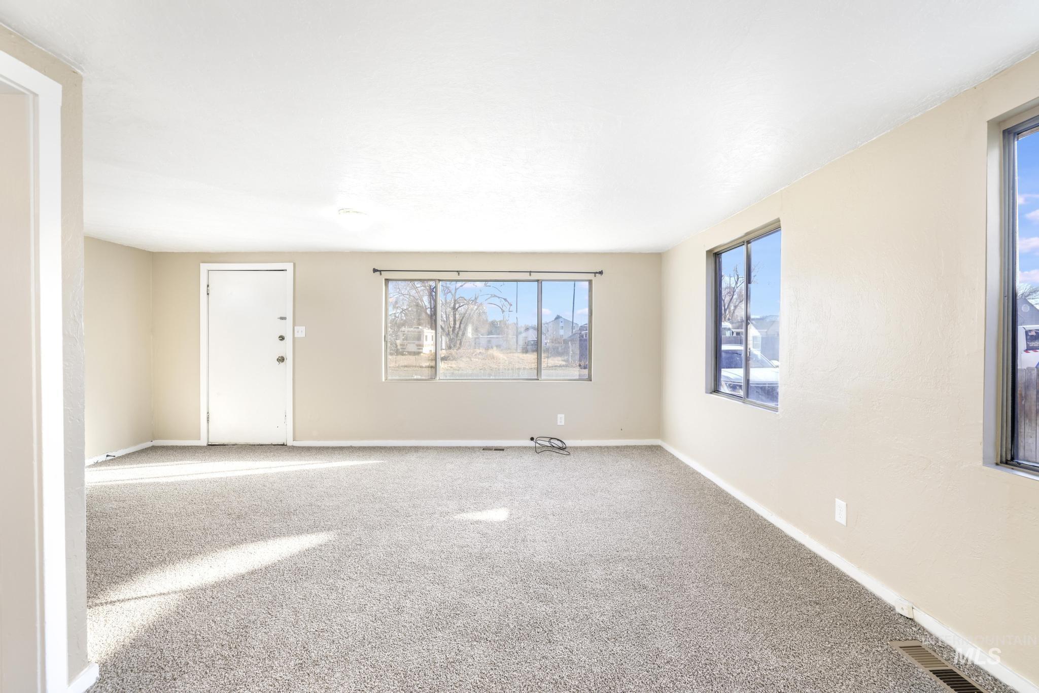 525 Adams Street Twin Falls, ID 83301 - Photo 4 of 31 Carpeted empty room with healthy amount of natural light