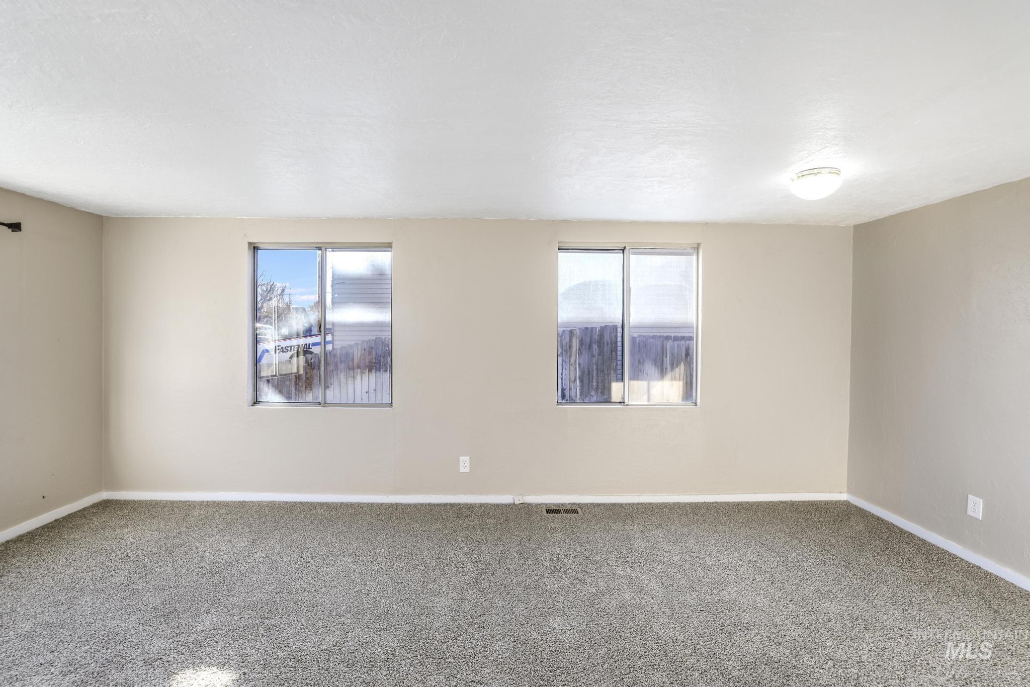 525 Adams Street Twin Falls, ID 83301 - Photo 6 of 31 Unfurnished room featuring healthy amount of natural light and carpet floors