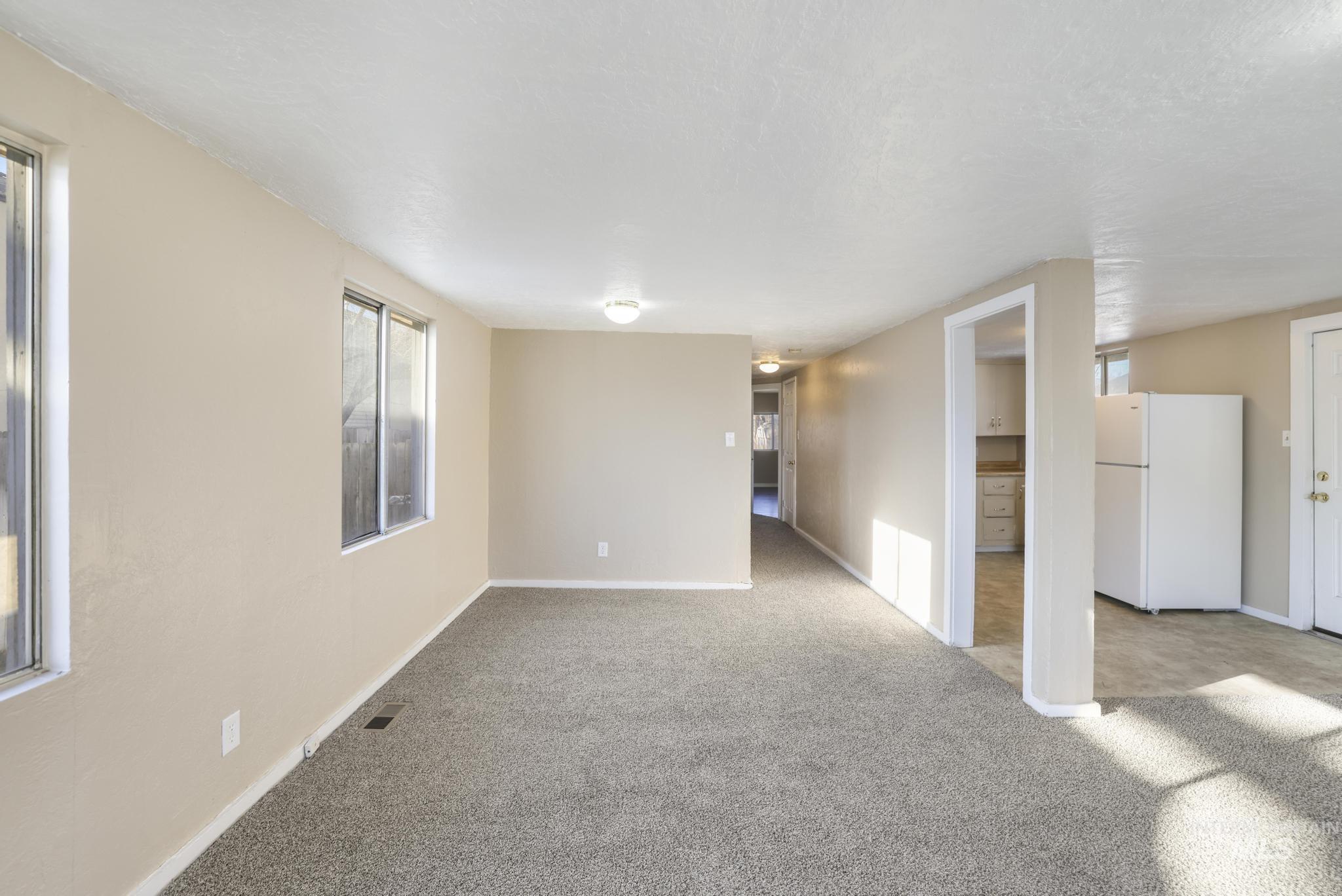 525 Adams Street Twin Falls, ID 83301 - Photo 7 of 31 Carpeted spare room with plenty of natural light and a textured ceiling