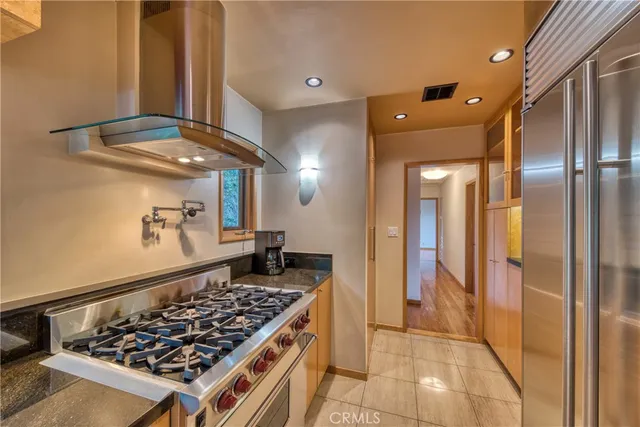 a kitchen with stainless steel appliances granite countertop a stove and a refrigerator