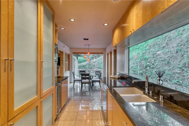 a very nice looking dining room with a large window and chandelier