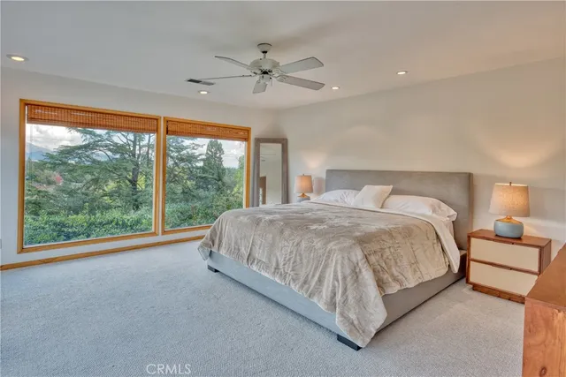 a spacious bedroom with a large bed and a large window