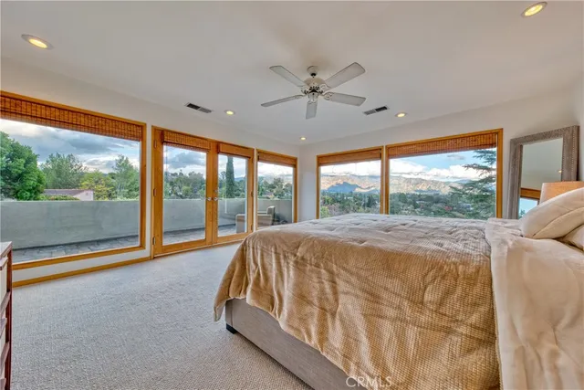 a bed sitting in a room next to a large window