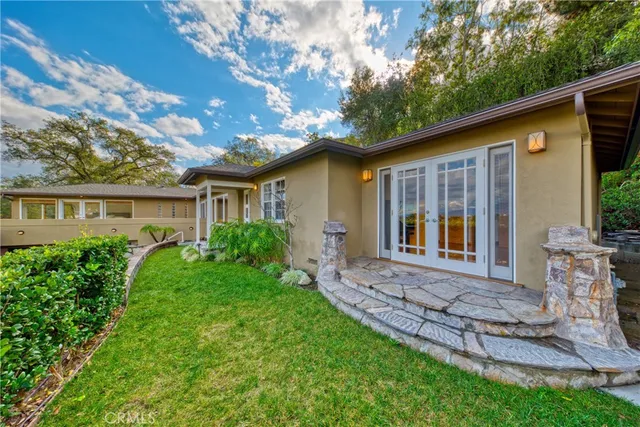 a view of house with a yard