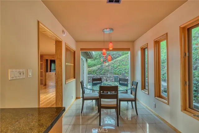 a view of a dining room with furniture large windows and wooden floor