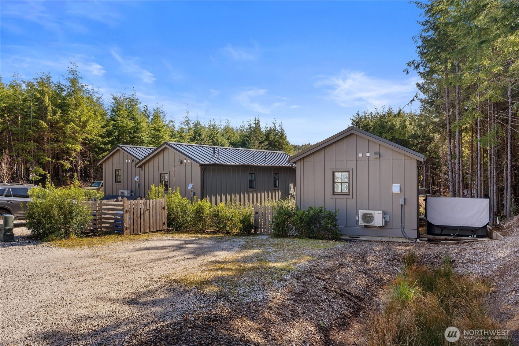 417 East Compass Street Pacific Beach, WA 98571 - Photo 23 of 40 a front view of a house with a yard and a garage
