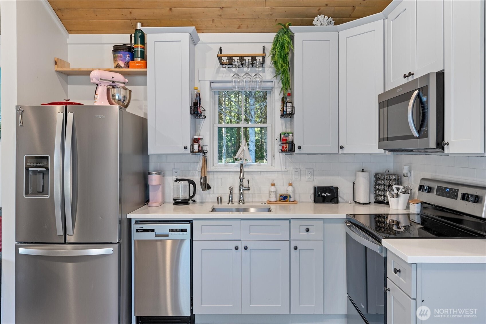 417 East Compass Street Pacific Beach, WA 98571 - Photo 7 of 40 a kitchen with stainless steel appliances granite countertop a refrigerator sink and stove