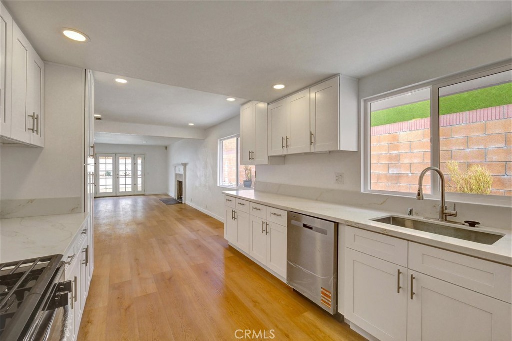 1807 East Calstock Street Carson, CA 90746 - Photo 4 of 11 a large kitchen with cabinets wooden floor and a sink