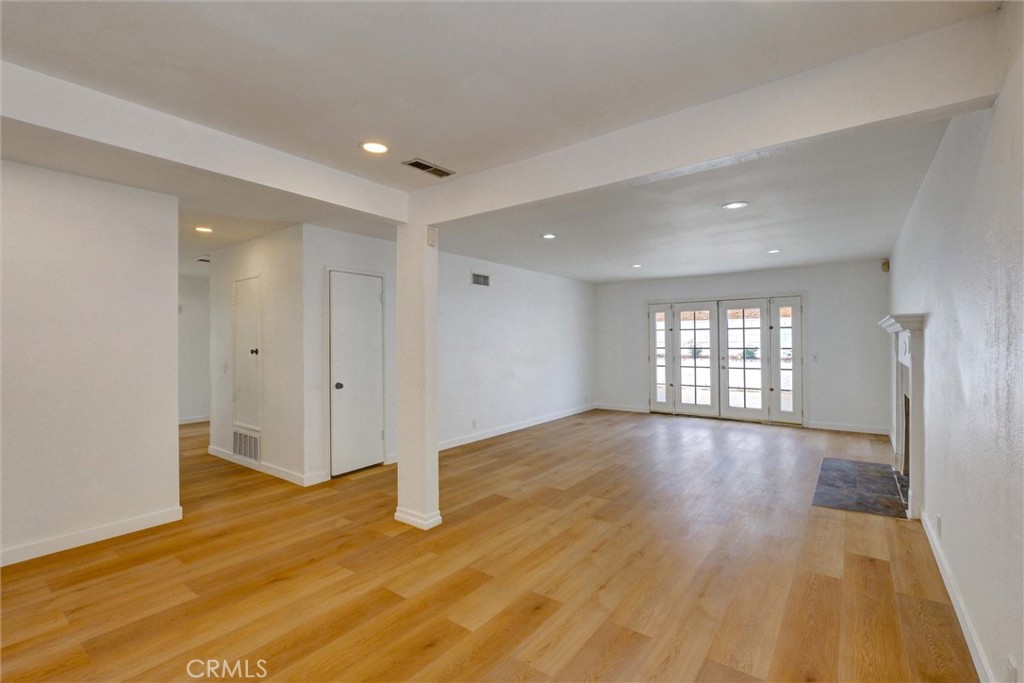 1807 East Calstock Street Carson, CA 90746 - Photo 7 of 11 a view of an empty room with wooden floor and a window