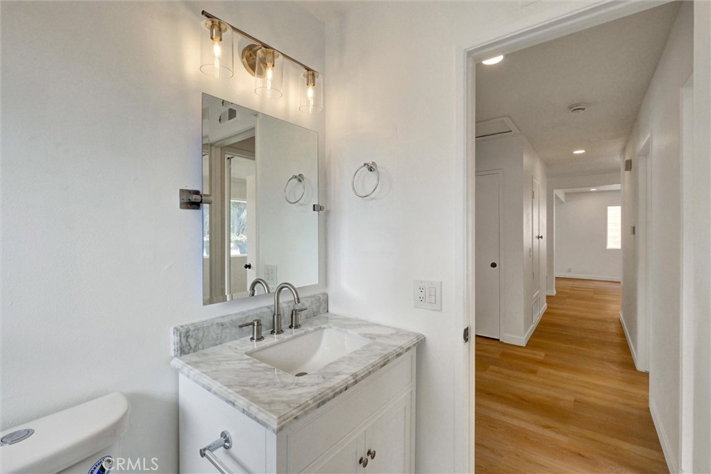 1807 East Calstock Street Carson, CA 90746 - Photo 8 of 11 a bathroom with a granite countertop sink and a mirror