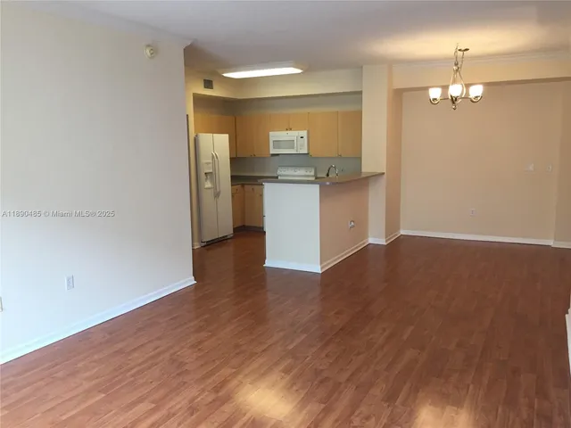 a view of kitchen with granite countertop cabinets and wooden floor