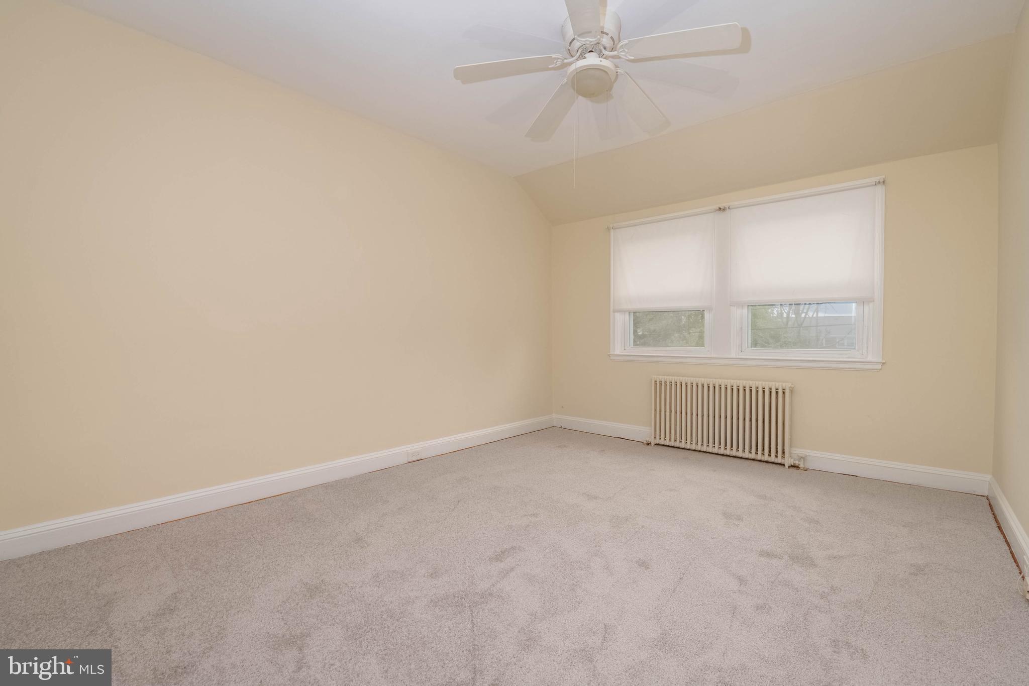 1325 Crofton Road Baltimore, MD 21239 - Photo 11 of 25 an empty room with a window and ceiling fan