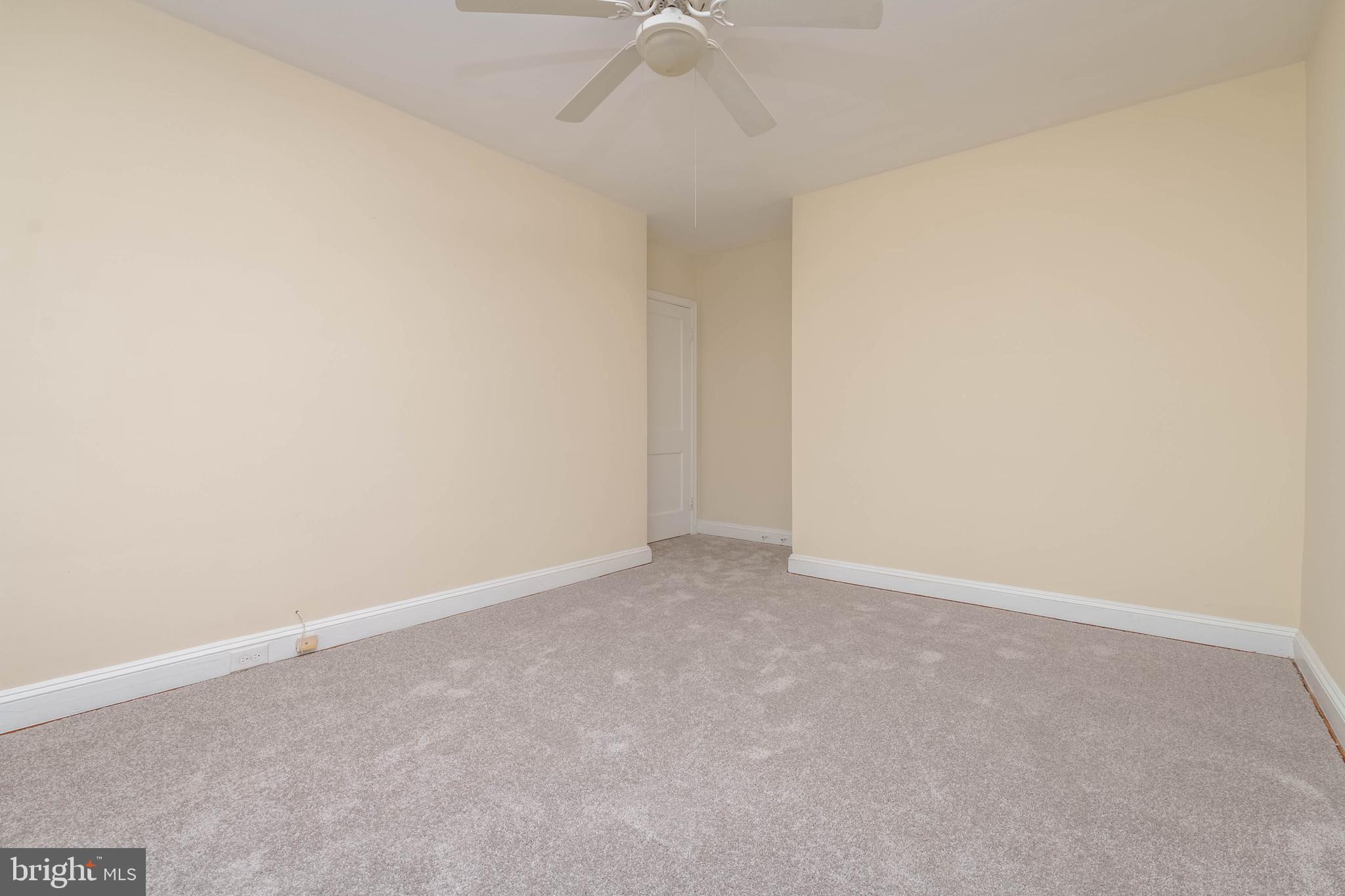 1325 Crofton Road Baltimore, MD 21239 - Photo 12 of 25 an empty room with a ceiling fan and carpet