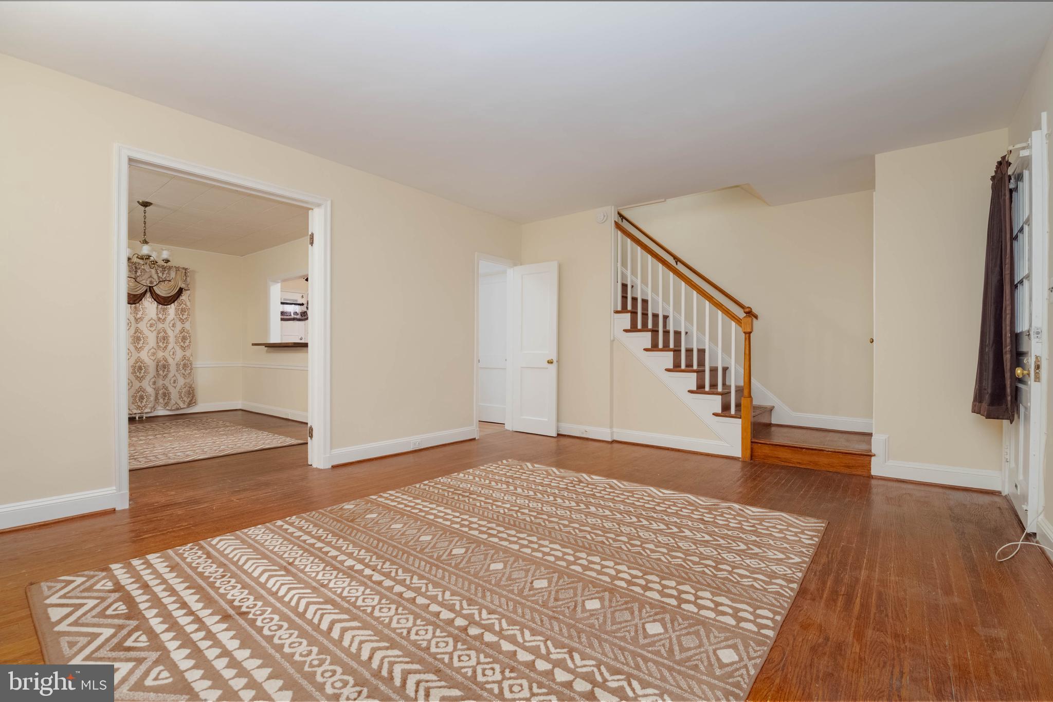 1325 Crofton Road Baltimore, MD 21239 - Photo 2 of 25 a view of an empty room with wooden floor and stairs