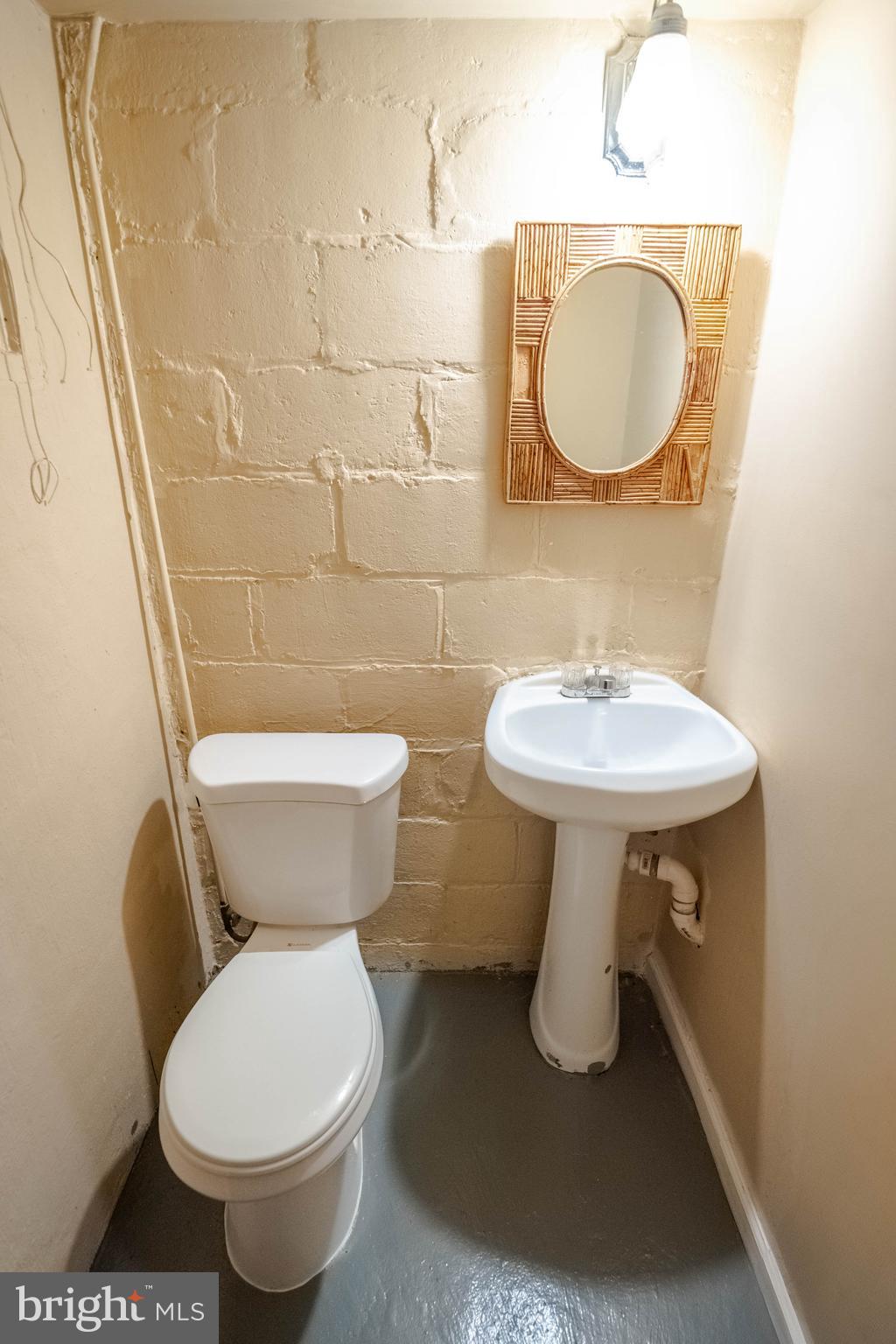 1325 Crofton Road Baltimore, MD 21239 - Photo 21 of 25 a bathroom with a sink toilet and a mirror