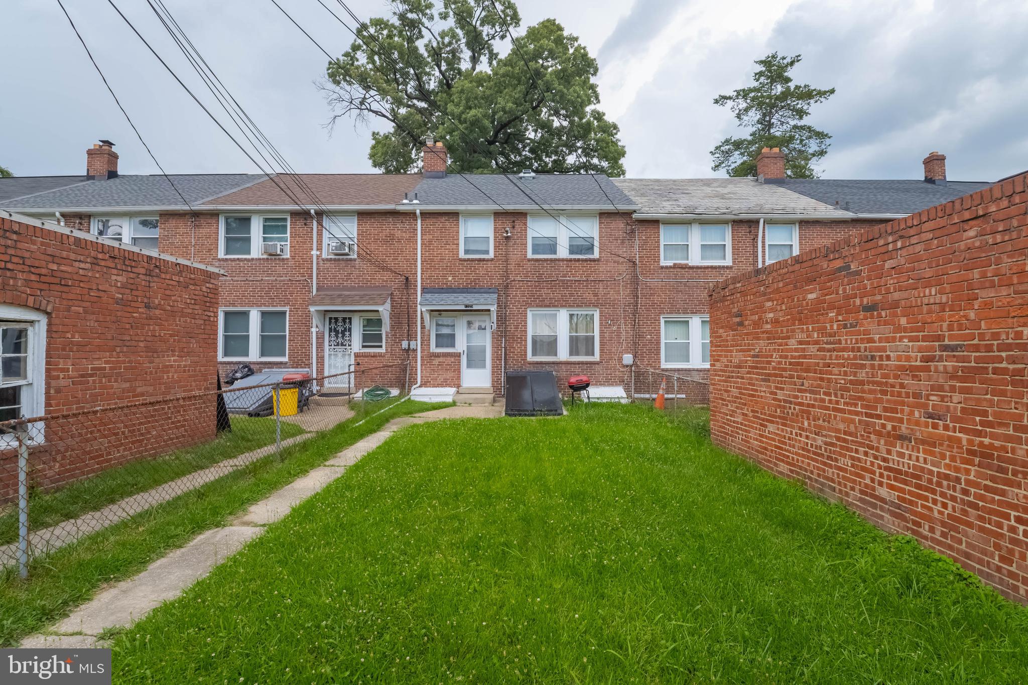 1325 Crofton Road Baltimore, MD 21239 - Photo 23 of 25 a front view of a house with a yard