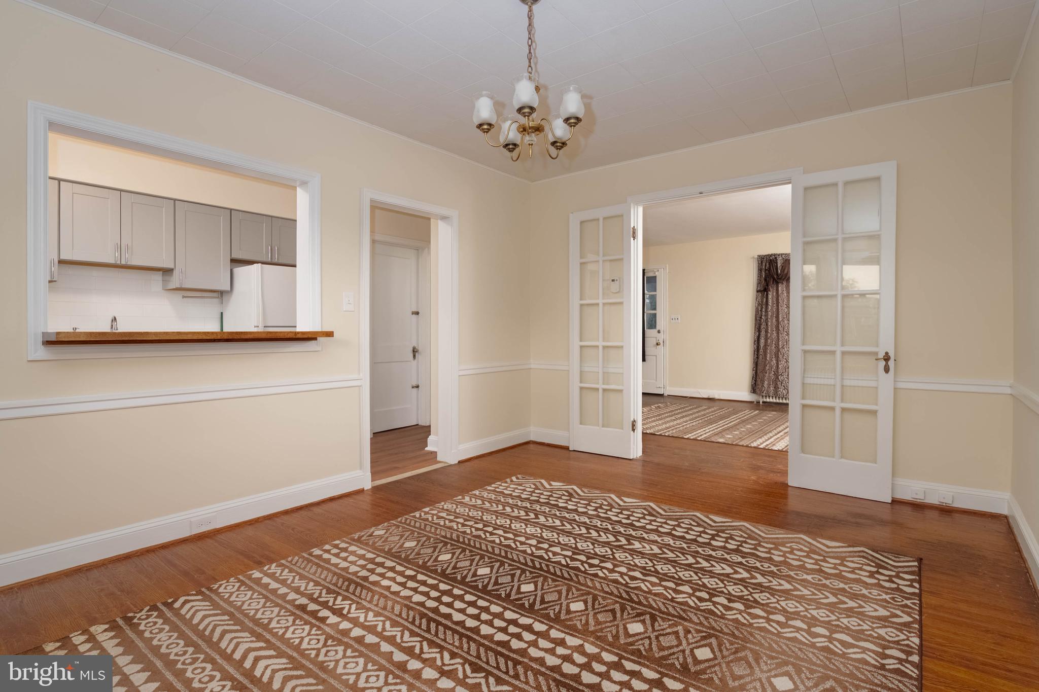 1325 Crofton Road Baltimore, MD 21239 - Photo 5 of 25 wooden floor in an empty room with a window