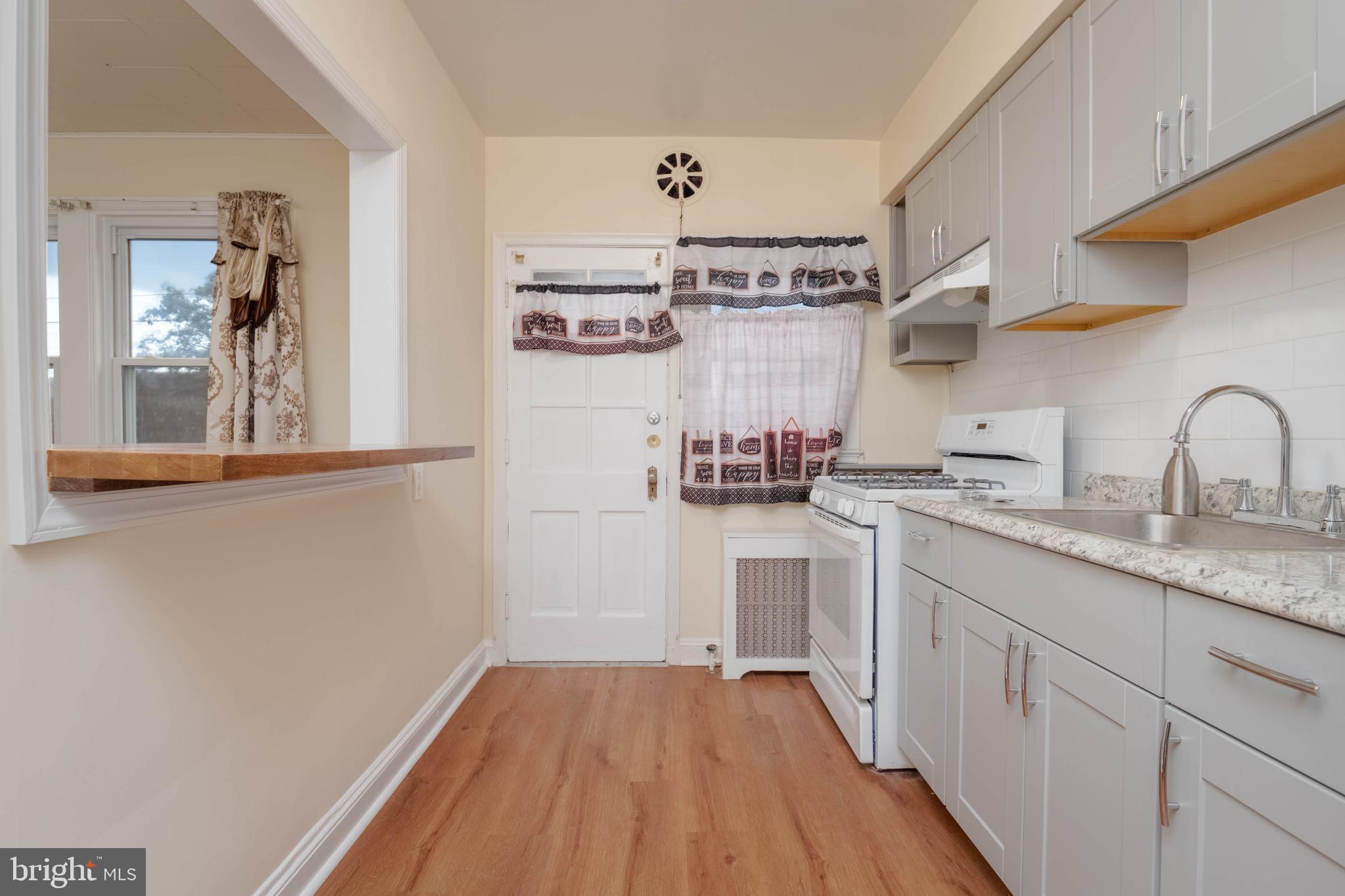 1325 Crofton Road Baltimore, MD 21239 - Photo 7 of 25 a kitchen with cabinets a sink and appliances