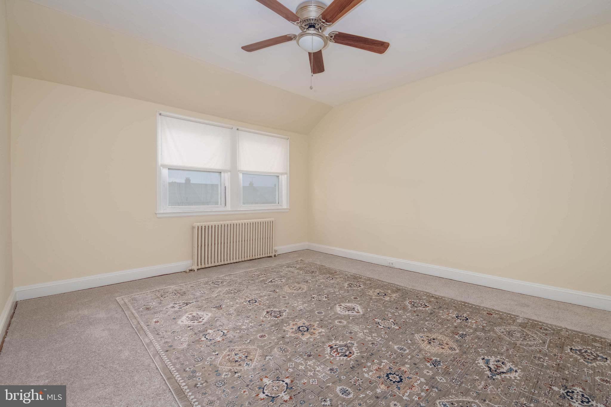 1325 Crofton Road Baltimore, MD 21239 - Photo 9 of 25 an empty room with windows and fan