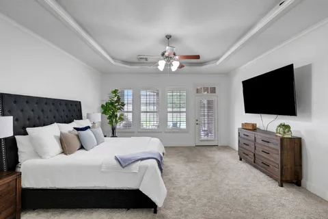 a bedroom with a large bed and a flat screen tv