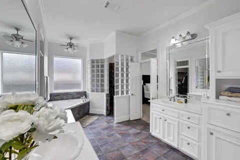 a bathroom with a sink double vanity and a shower