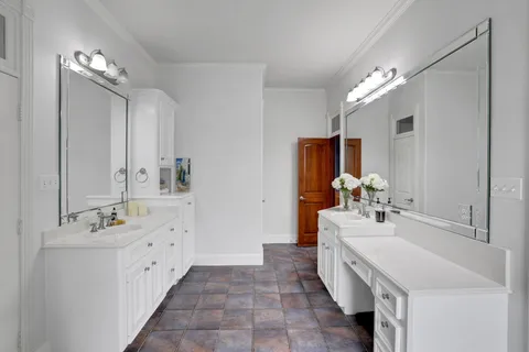 a bathroom with a double vanity sink mirror and