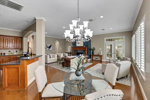 a living room with fireplace furniture and a chandelier