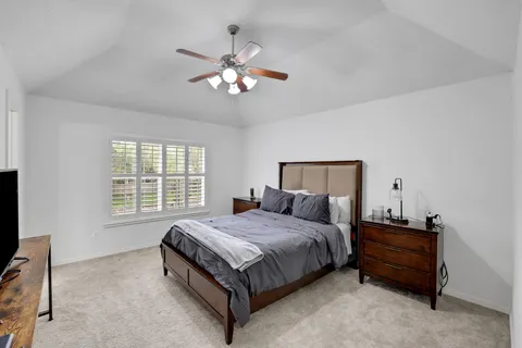 a bedroom with a bed and a chandelier