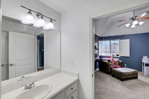 a en suite bathroom with a double vanity sink and a mirror