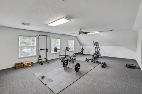 a very nice looking room with gym equipment and a window