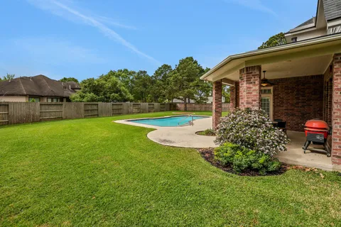a view of a house with a yard and sitting area