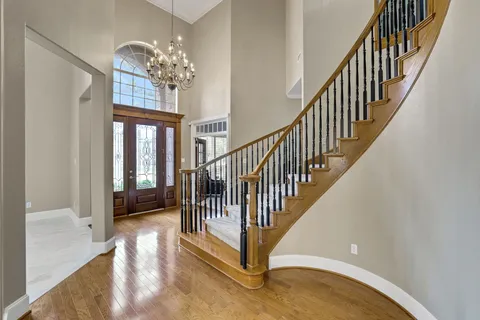 a view of entryway and hall with wooden floor
