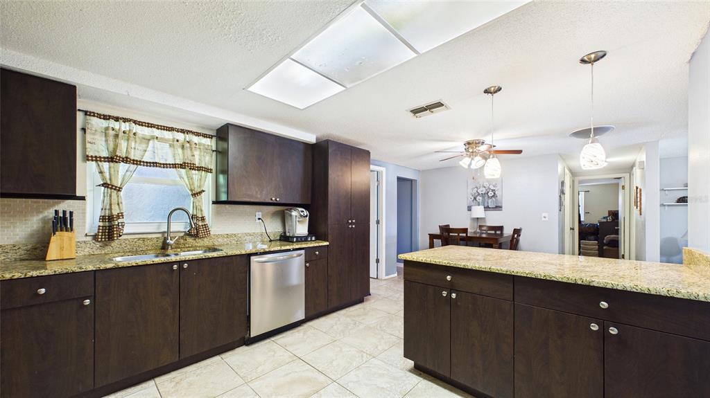 8840 Carmen Lane Port Richey, FL 34668 - Photo 15 of 49 a bathroom with a granite countertop sink double vanity and a mirror