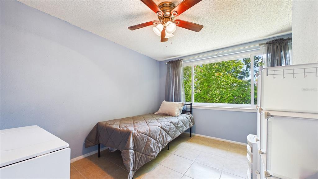 8840 Carmen Lane Port Richey, FL 34668 - Photo 18 of 49 a bedroom with a bed and a chandelier