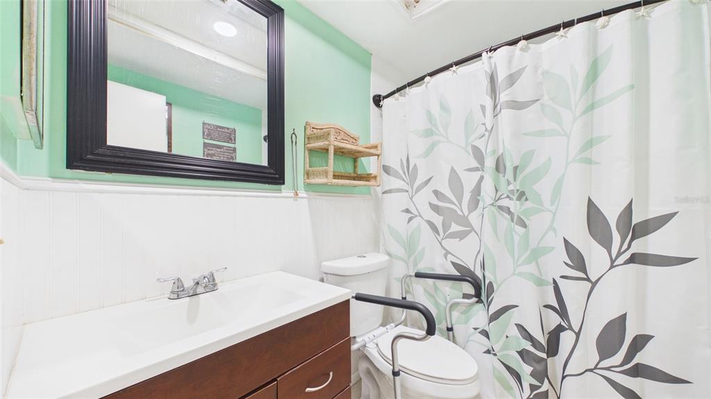 8840 Carmen Lane Port Richey, FL 34668 - Photo 22 of 49 a bathroom with a sink a toilet and a mirror