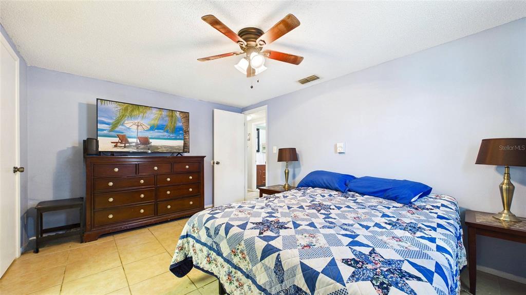 8840 Carmen Lane Port Richey, FL 34668 - Photo 27 of 49 a bedroom with a bed and a dresser in it
