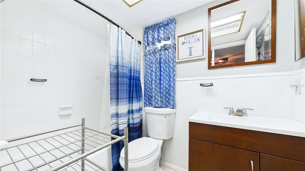 8840 Carmen Lane Port Richey, FL 34668 - Photo 28 of 49 a bathroom with a sink a toilet and shower