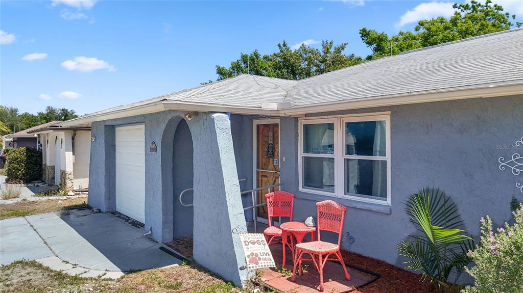 8840 Carmen Lane Port Richey, FL 34668 - Photo 3 of 49 a backyard of a house with table and chairs