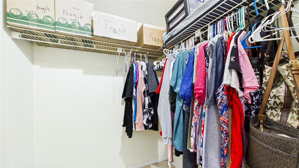 8840 Carmen Lane Port Richey, FL 34668 - Photo 31 of 49 a view of walk in closet with clothes