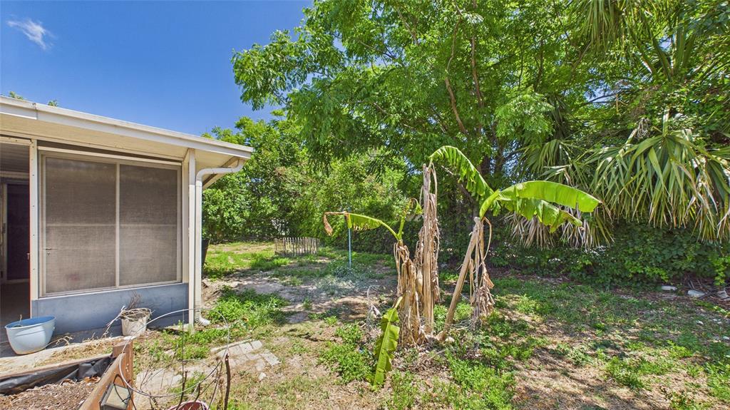 8840 Carmen Lane Port Richey, FL 34668 - Photo 38 of 49 a view of a backyard with plants and brick wall