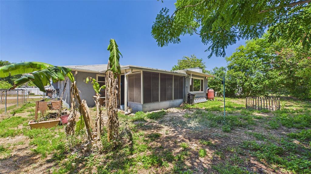 8840 Carmen Lane Port Richey, FL 34668 - Photo 39 of 49 a view of a house with a small yard and plants