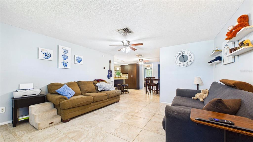 8840 Carmen Lane Port Richey, FL 34668 - Photo 5 of 49 a living room with furniture and a chandelier