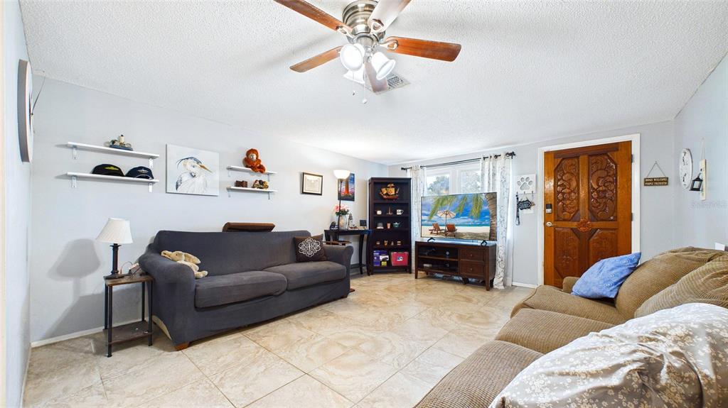 8840 Carmen Lane Port Richey, FL 34668 - Photo 7 of 49 a living room with furniture and a baby crib