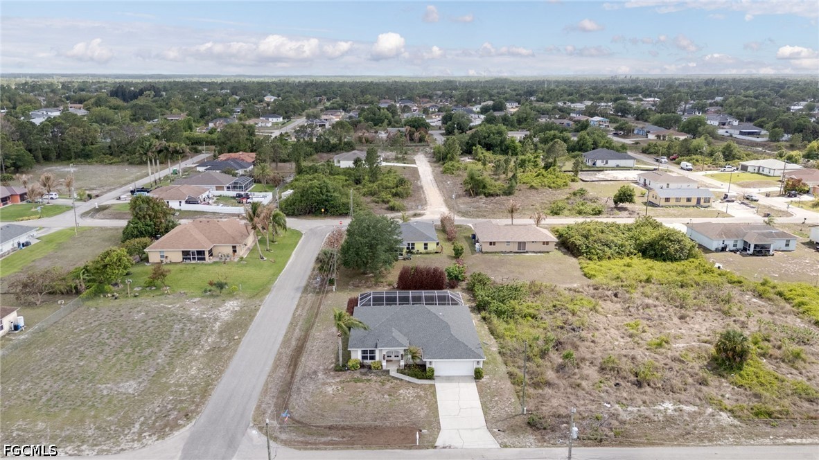3801 28th Street Southwest Lehigh Acres, FL 33976 - Photo 28 of 37 an aerial view of residential houses with outdoor space