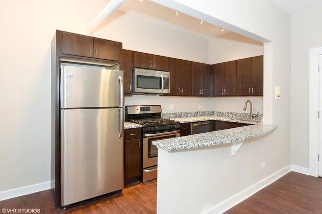 a kitchen with a refrigerator sink and microwave