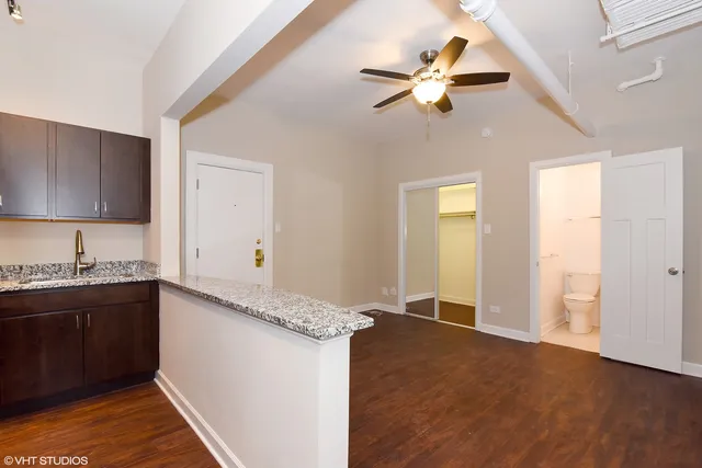 a kitchen with granite countertop a sink stainless steel appliances and cabinets