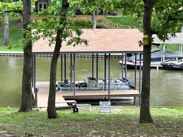 a backyard of a house with yard table and chairs