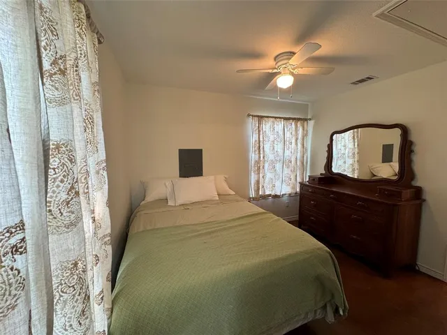 a bedroom with a large bed and a tv