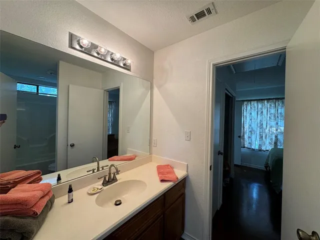 a en suite bathroom with a sink and a mirror