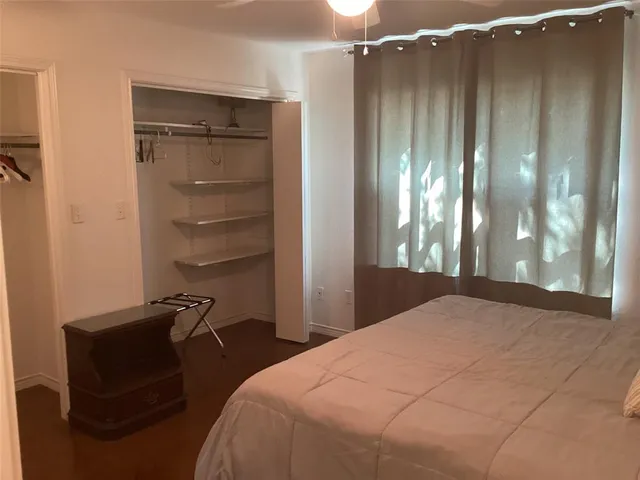 a bedroom with a bed and a mirror